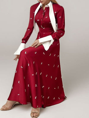 Burgundy midi dress with contrast collar, button-down front, defined waist, and scattered white floral print.