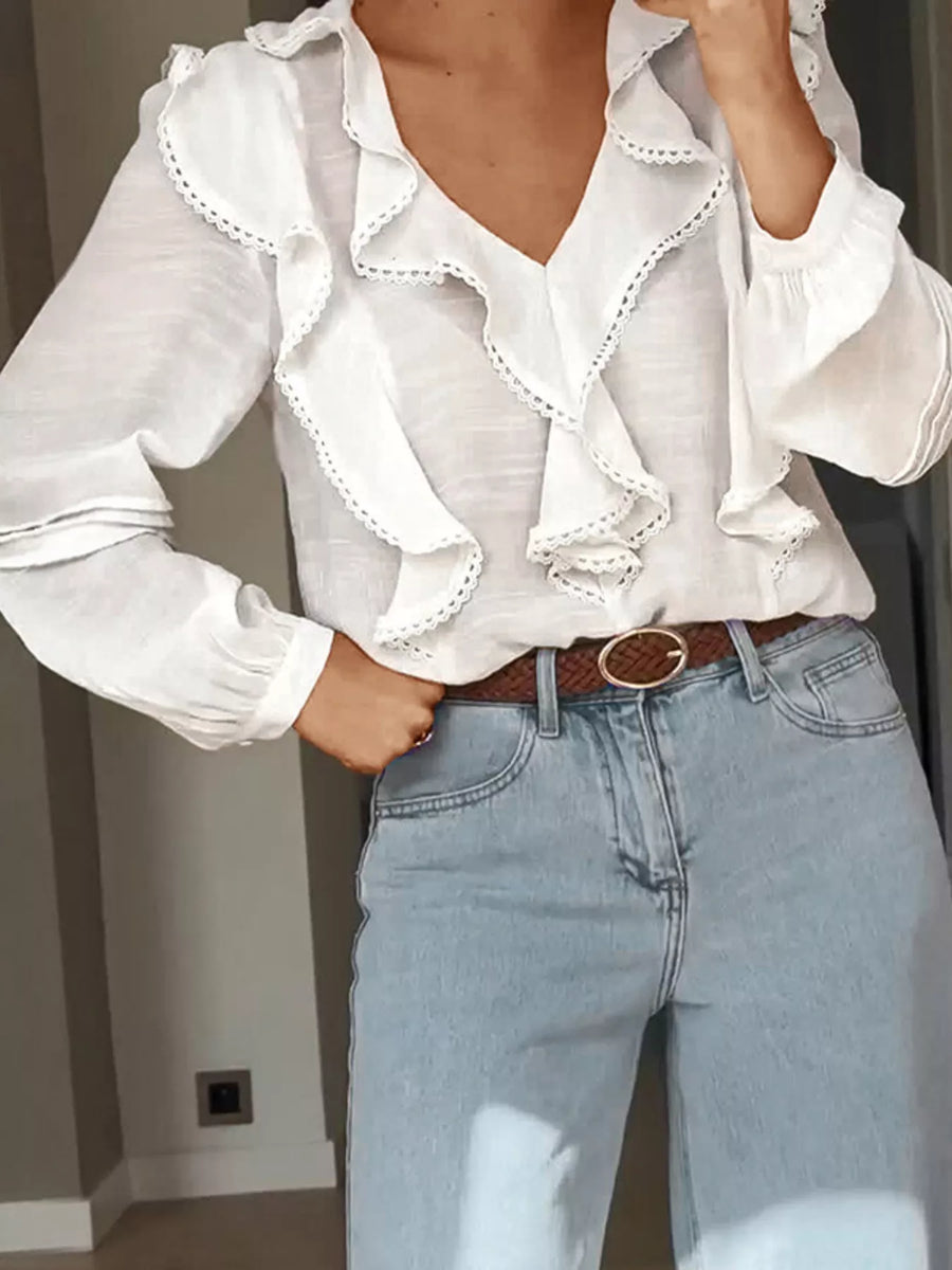 White lace ruffle v-neck blouse with long sleeves and lace trim detail.