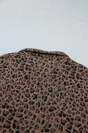 Brown leopard jacquard textured half-zip shirt with a collar.