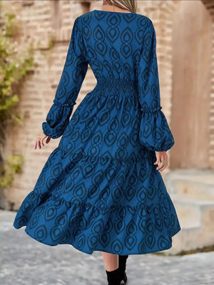 Blue abstract pattern midi dress with smocked waist and tiered ruffle skirt.