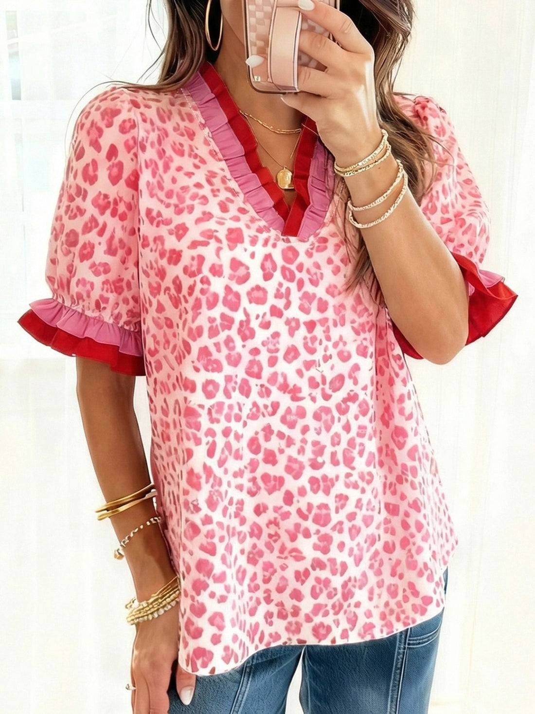 Ruffled leopard print blouse in strawberry pink with contrast red and pink trim.