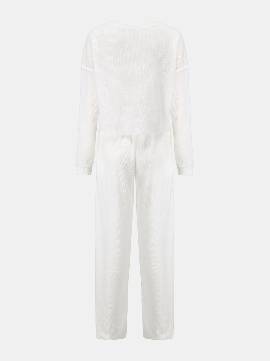 White waffle knit cropped lounge set with long sleeves and wide-leg pants.