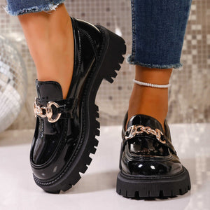 Chunky lug sole loafers in gloss black with gold chain detail.