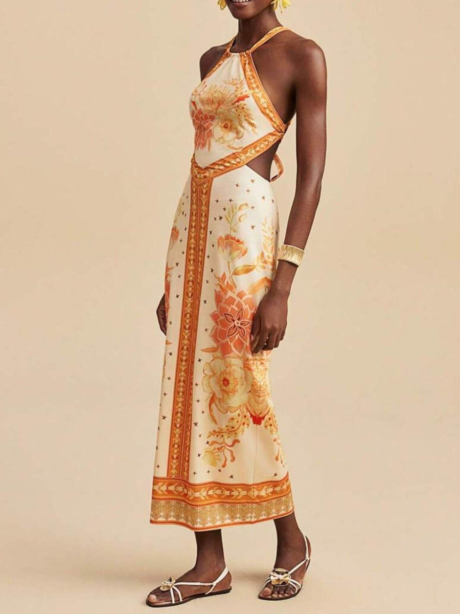Floral print backless maxi dress with halter neck and side cutouts.