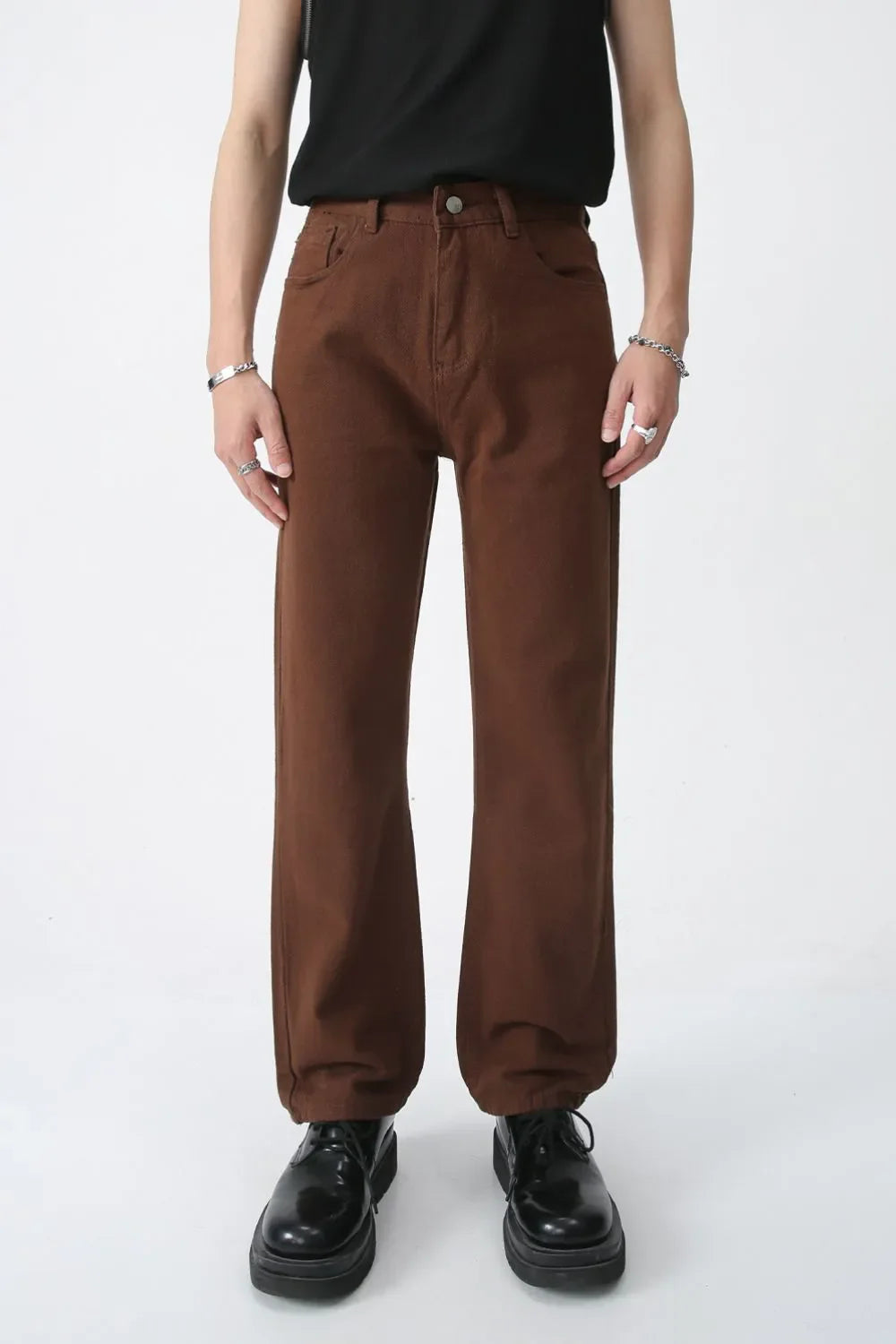Relaxed fit chino trousers in chocolate brown, styled with black shoes.