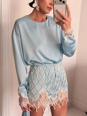 Light blue satin oversized t-shirt with lace trim on cuffs and hem.