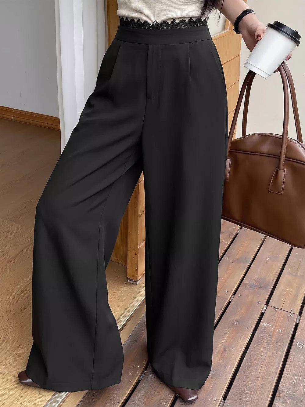 wide-leg pants in black featuring lace detail and flared fit