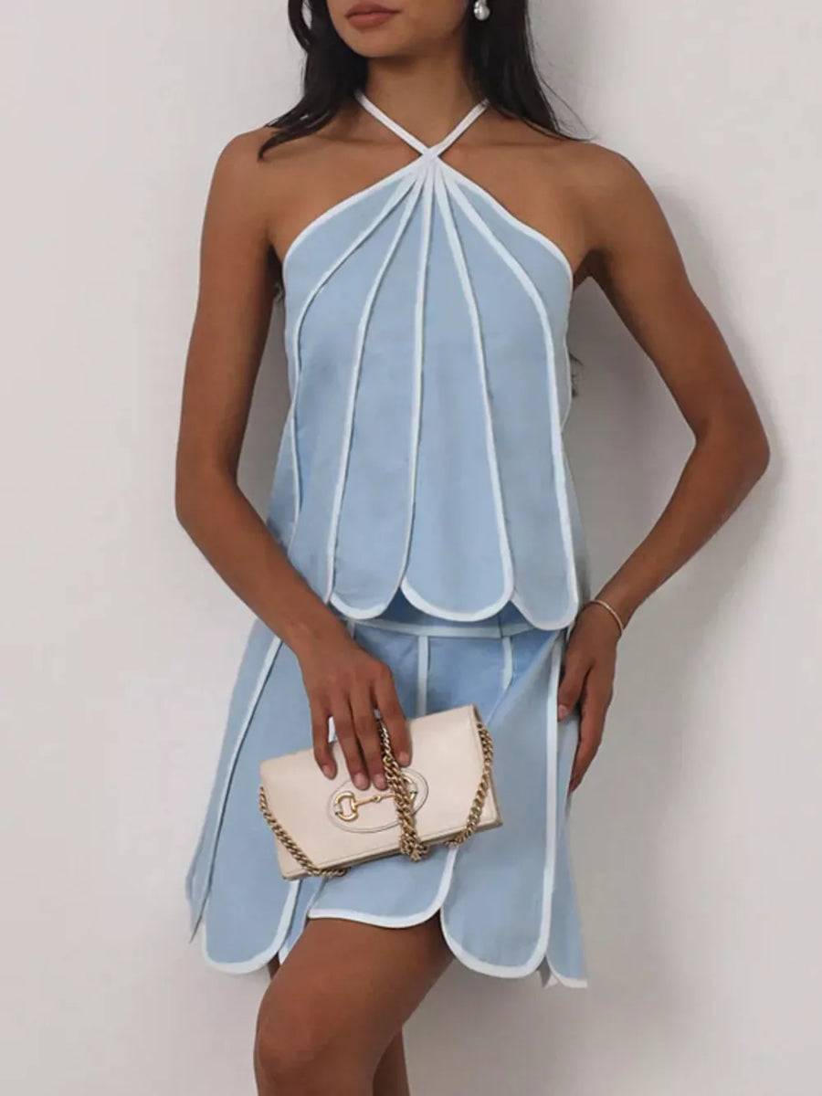 Light blue halter top with white trim and a matching scalloped hem skirt.