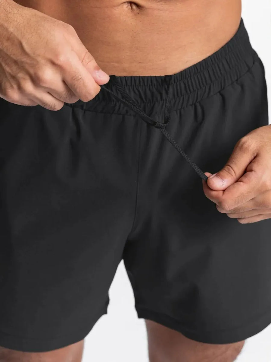 Black performance drawstring running shorts with elastic waistband detail.