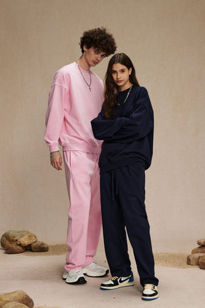 Pink crewneck sweatshirt and sweatpants with drawstring waist