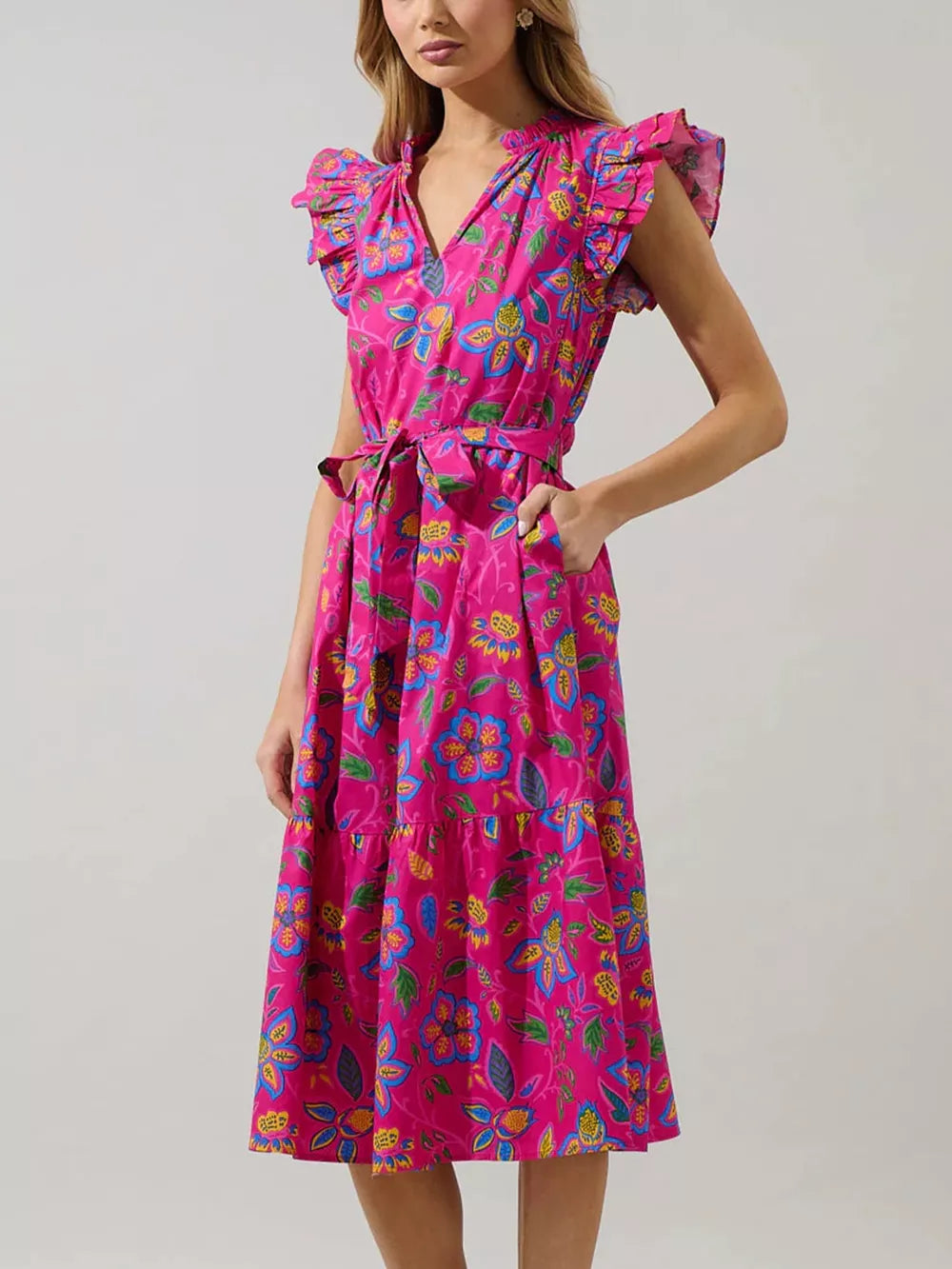 Floral midi dress with ruffled sleeves, V-neck, and belted waist in a cerise cotton blend.