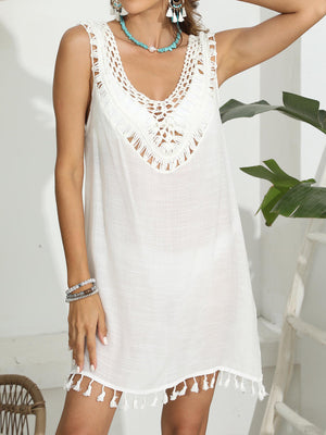 White crochet yoke tassel beach dress with V-neck and fringe hem.