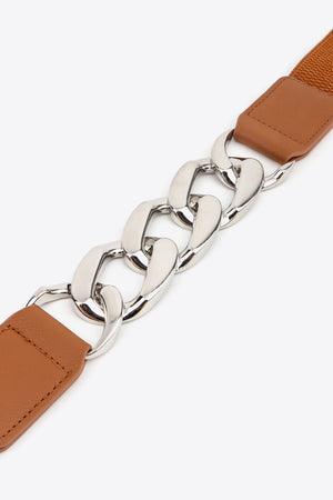 Chunky chain elastic belt with faux leather ends in ochre and silver hardware.