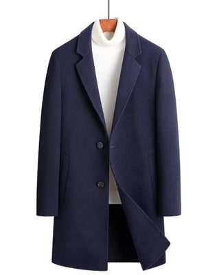 Men's navy blue wool blend overcoat with button closure and lapel collar, styled with a white turtleneck.