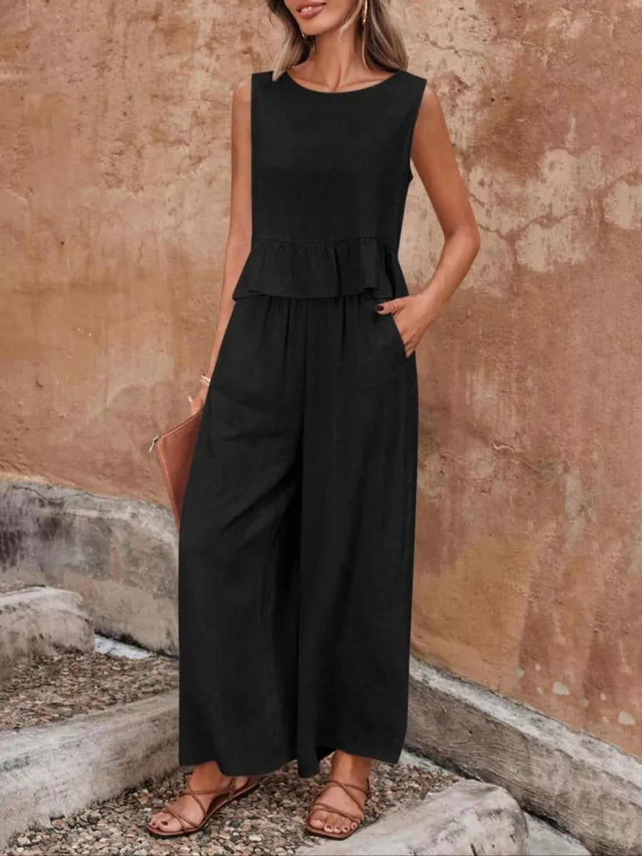 Black ruffled peplum top and wide-leg pants set with round neckline and sleeveless design.