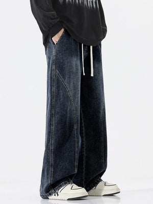 Relaxed fit dark wash wide-leg jeans with drawstring and contrast stitching.