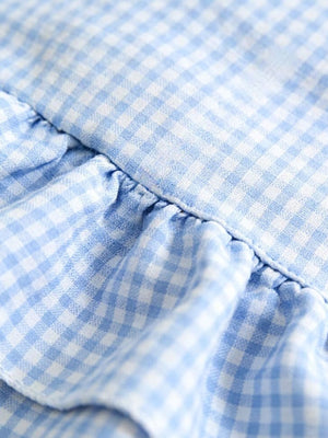 Baby dress in pastel blue gingham with ruffled detail