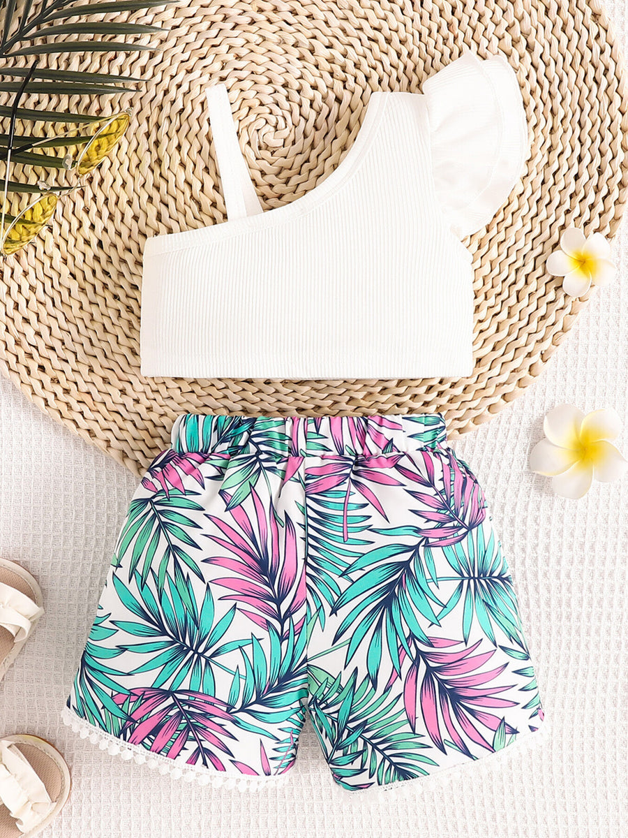 White asymmetrical top with ruffled sleeve and floral print shorts with pom-pom trim