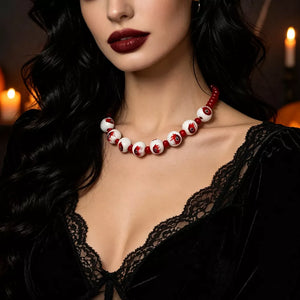 red necklace featuring beaded and graphic
