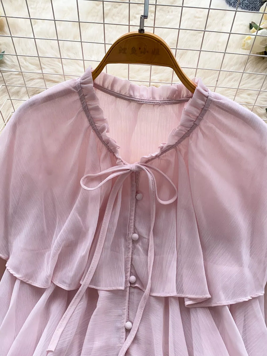 Pink chiffon blouse with ruffled neckline, bow tie, and button front.