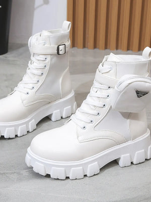 White utility pocket lug sole boots with buckle detail and chunky sole.