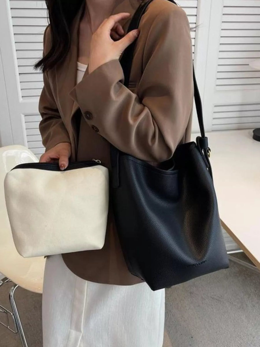 Black pebbled PU leather shoulder bag with a white canvas pouch.