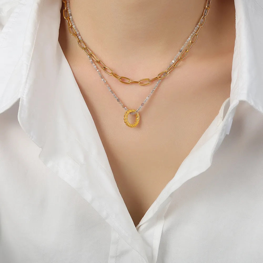 Gold layered chain and beaded necklace with textured oval pendant