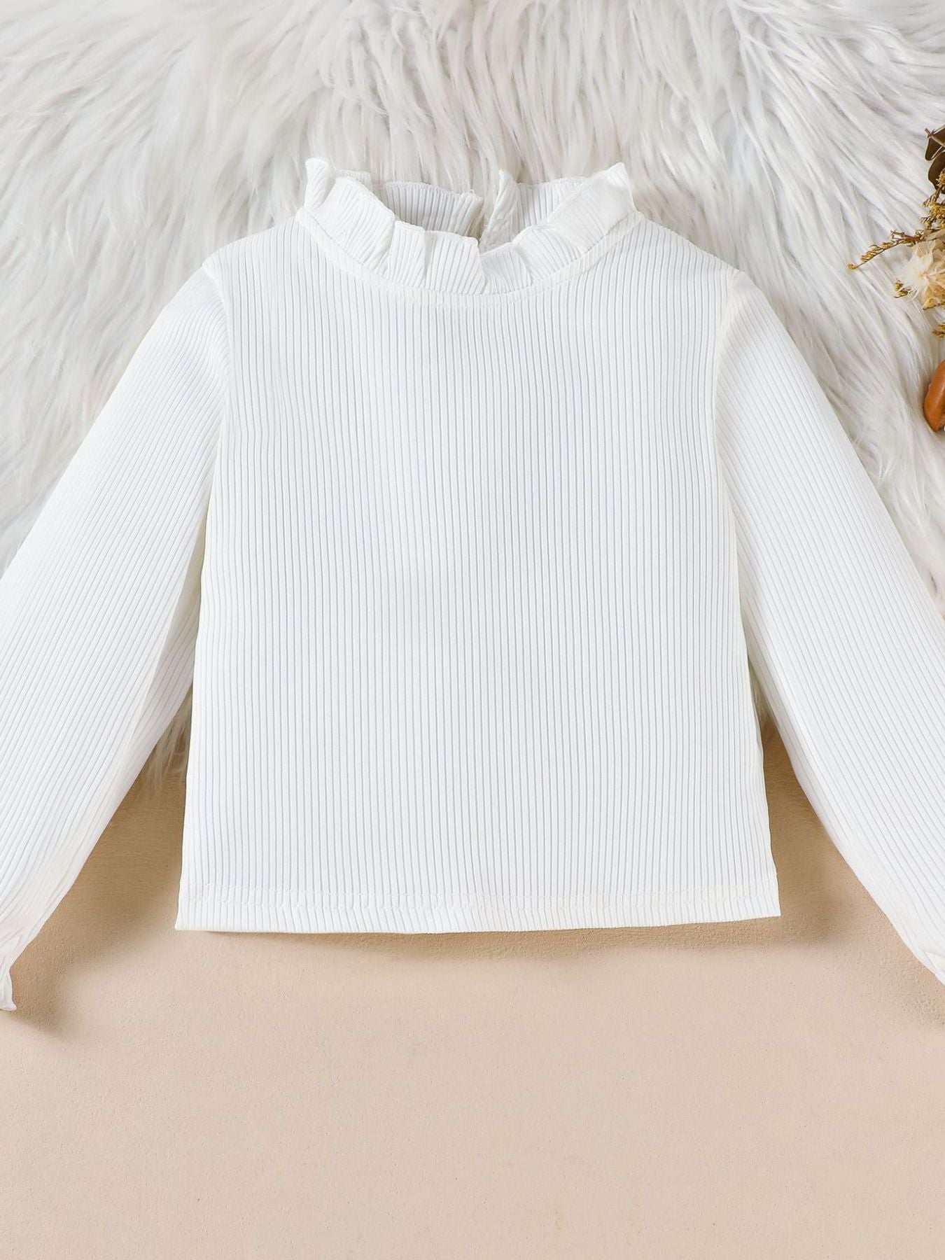 White ribbed long sleeve top with ruffled mock neck and cuffs
