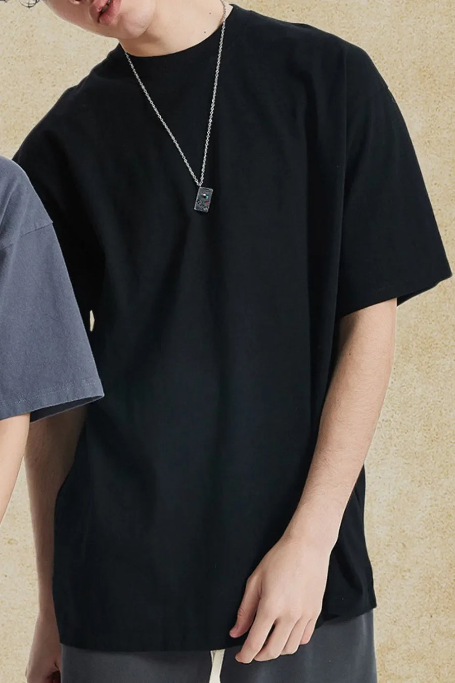 Black oversized crewneck tee with relaxed fit and short sleeves.