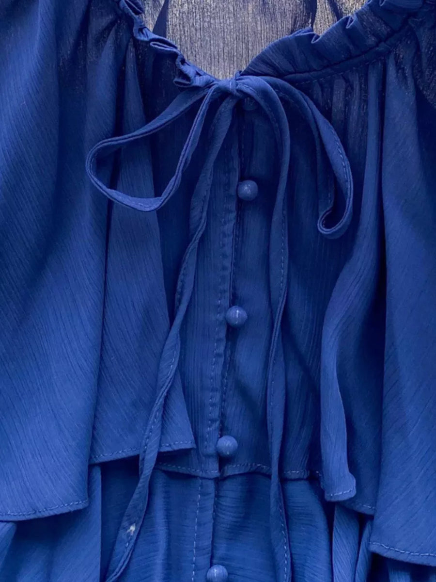 Blue chiffon blouse with tiered ruffles, button front, and bow tie neckline.