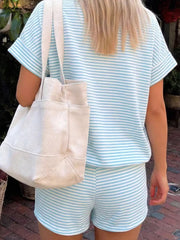 Light blue and white striped t-shirt and shorts set with cuffed sleeves and a canvas tote bag.