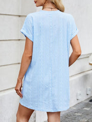 Light blue eyelet mini dress with diamond pattern and crew neck.