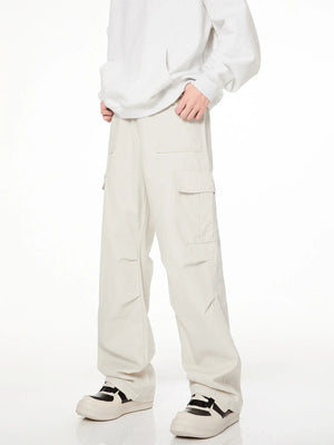 Men's loose fit cargo pants in creamy-white with multiple pockets.