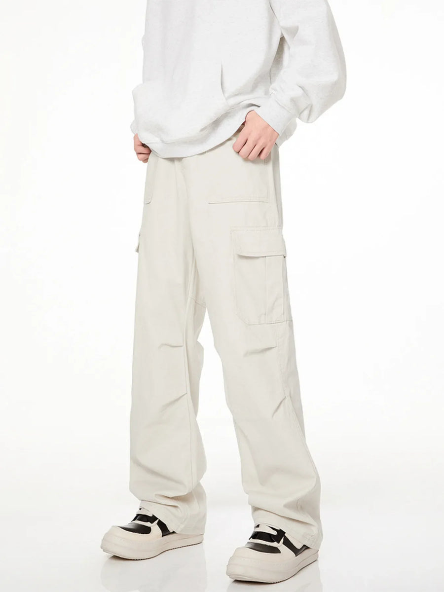 Men's loose fit cargo pants in creamy-white with multiple pockets.