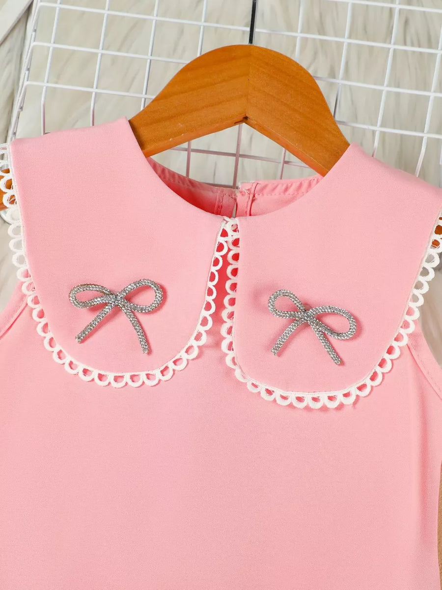 Pink toddler dress with Peter Pan collar, lace trim, and two sparkly bows.