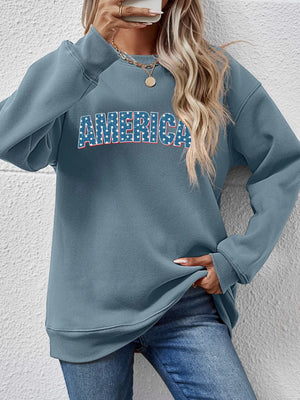 Misty Blue crewneck sweatshirt with America graphic, crew neckline, and long sleeves.