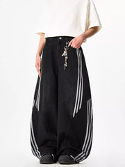 Black wide-leg jeans with white side stripes and acid wash detail.