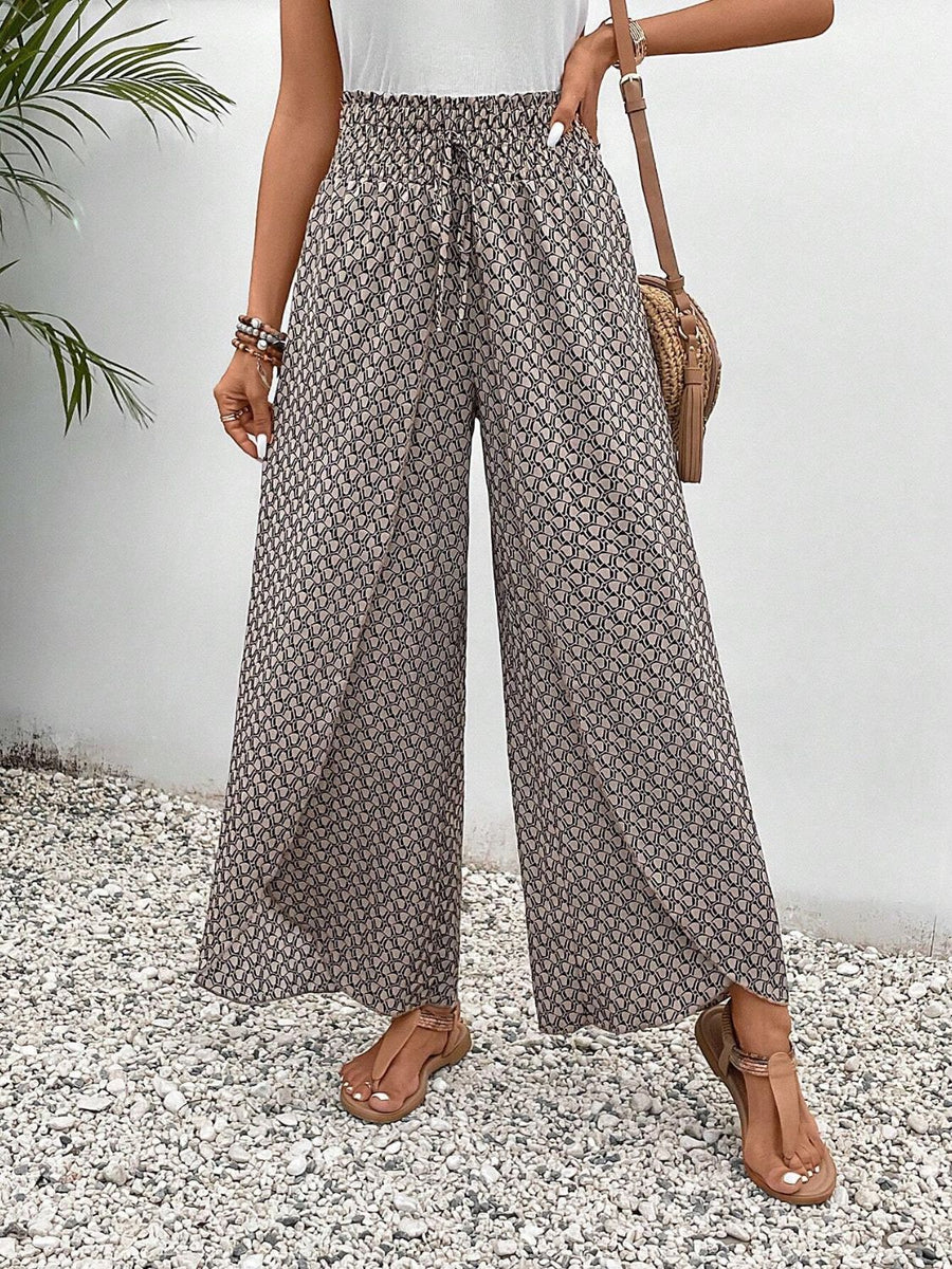 Palazzo pants with a geometric print, elastic waist, and drawstring.