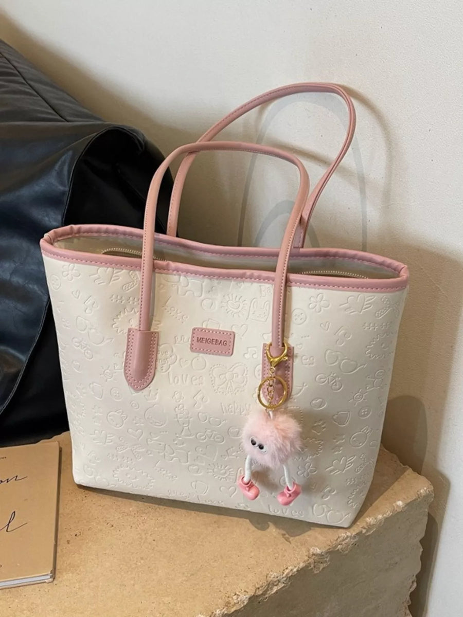 Embossed PU leather tote bag in cream with pink trim and a fluffy charm.