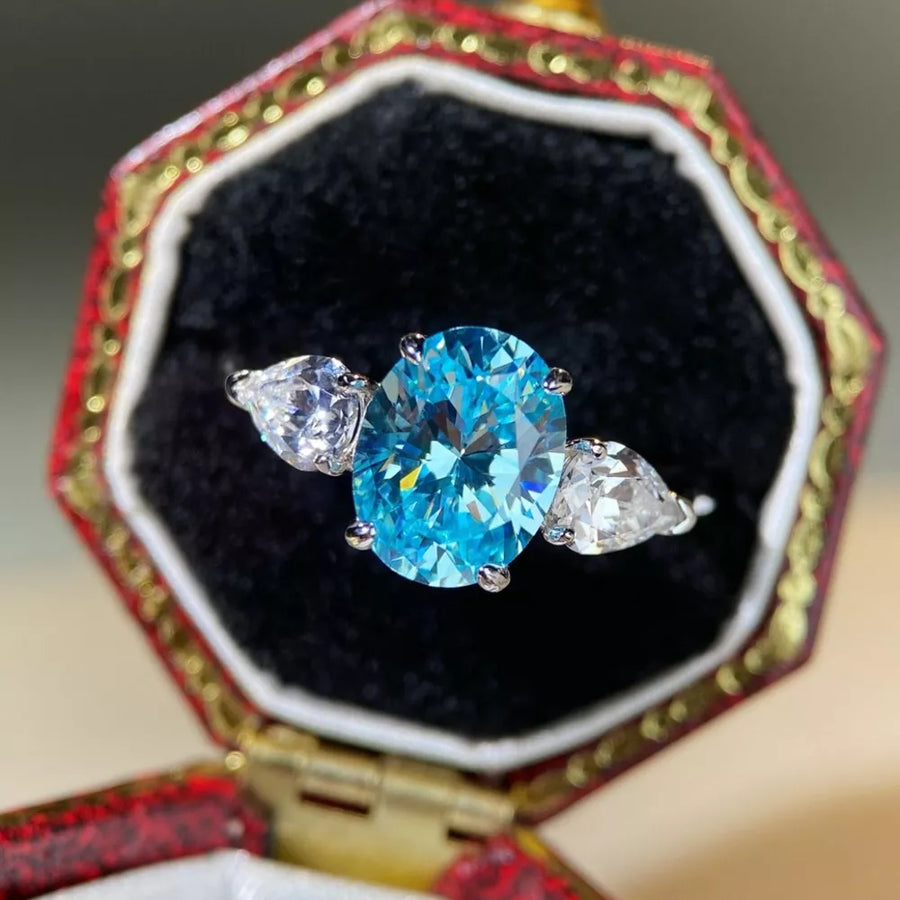 ring in sky blue featuring oval-cut stone and three-stone fit