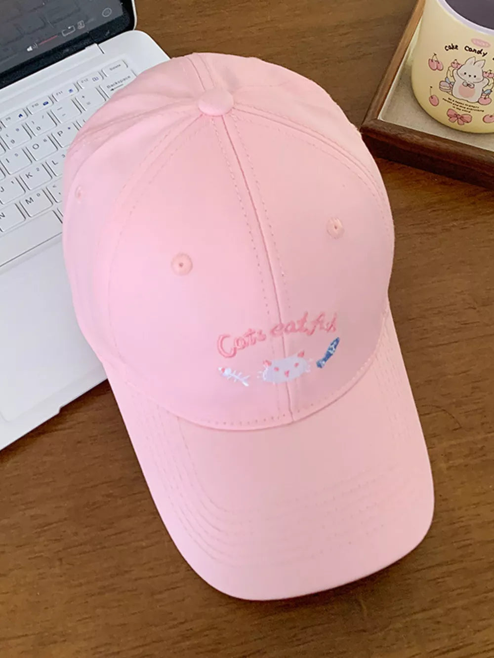 Pink baseball hat with cat embroidery and fish accents