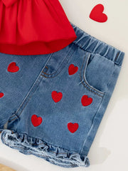 Red bowknot top with denim shorts featuring red heart embroidery and ruffled hem.