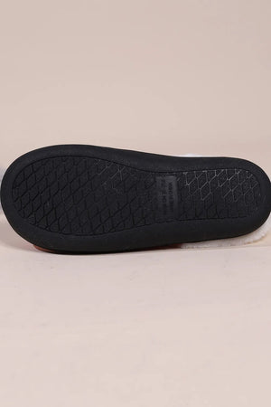 Snowman print faux fur lined slippers with black sole and white fuzzy trim.