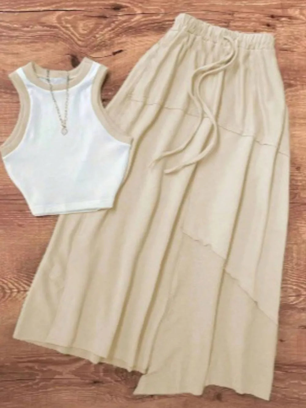 White ribbed tank top with tan trim and a tan tiered maxi skirt with drawstring waist.