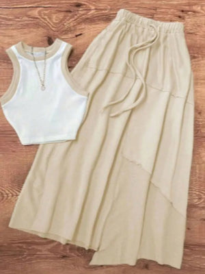 White ribbed tank top with tan trim and a tan tiered maxi skirt with drawstring waist.