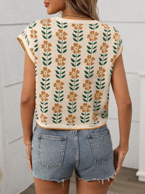 Floral knit sleeveless top in cream with orange flowers and green leaves pattern.