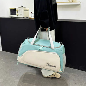 Light green and cream waterproof duffel bag with pockets and embroidered text.