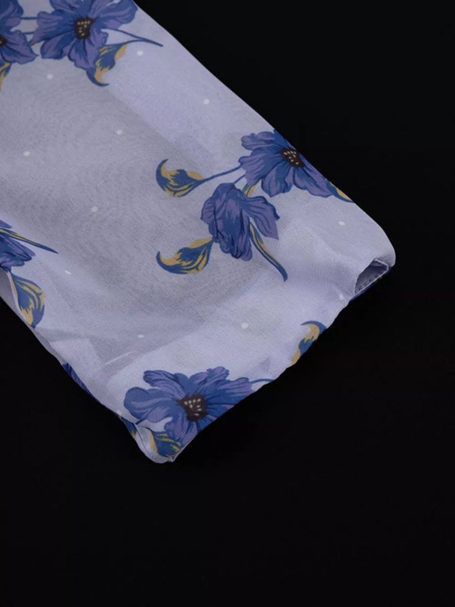 Sheer fabric blouse with blue floral print and white polka dots.