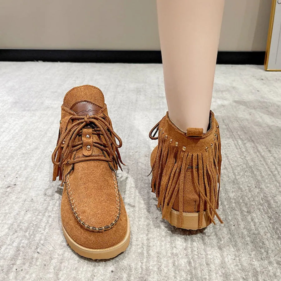 Brown fringed moc-toe ankle boots with lace-up closure and studded detail.