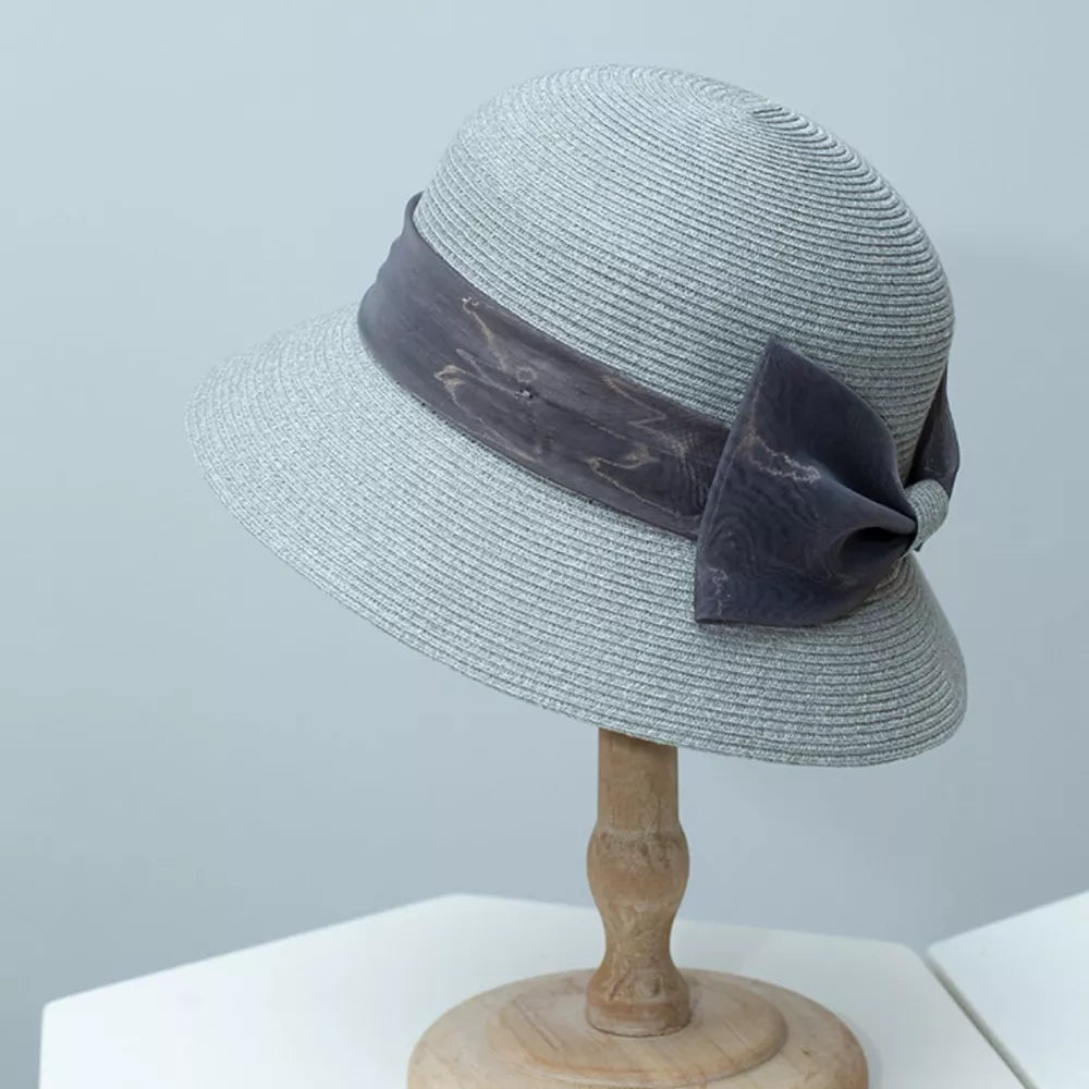 Chic gray cloche sun hat with a decorative ribbon bow detail.